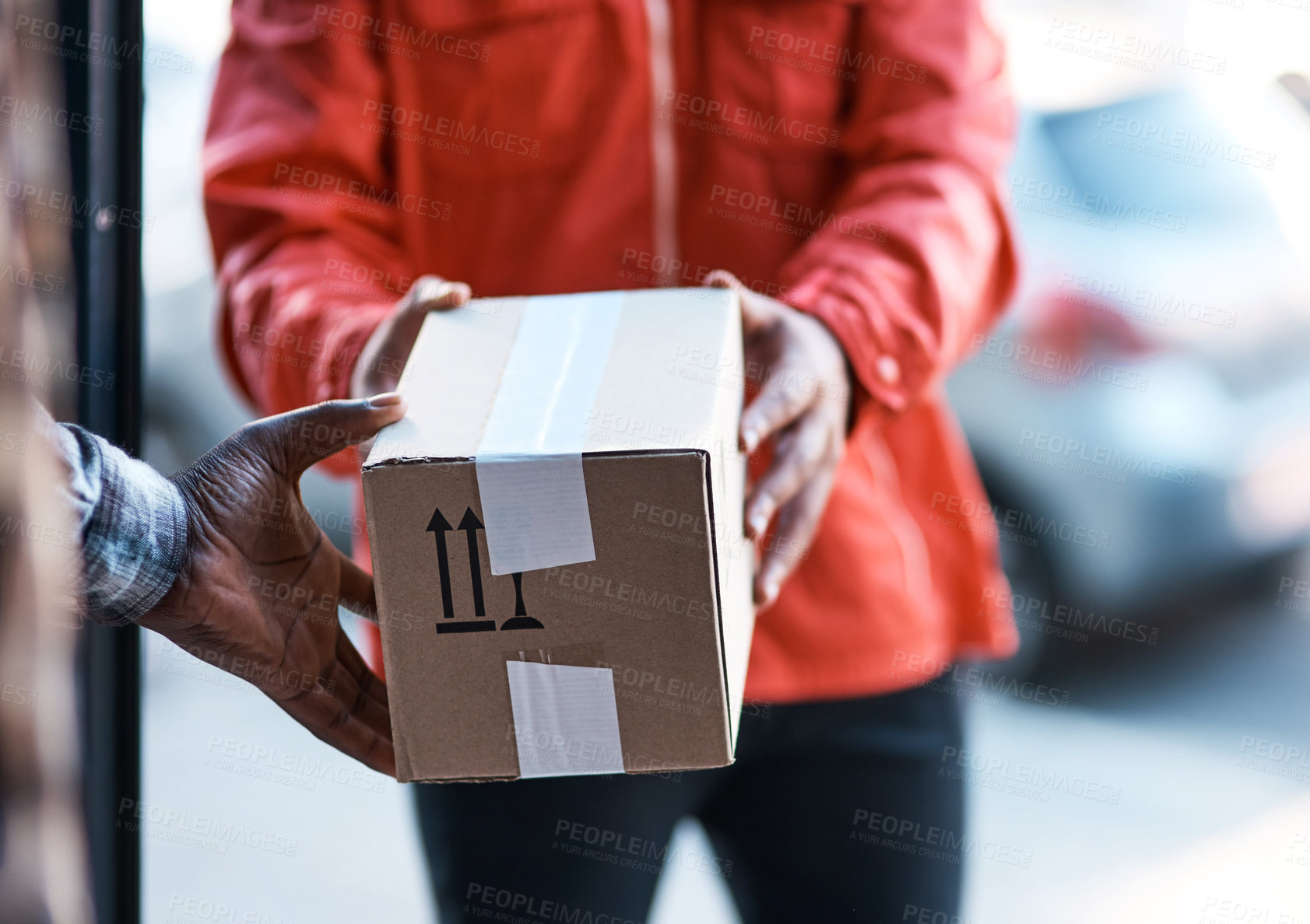 Buy stock photo Cropped shot of a delivery man handing over a package