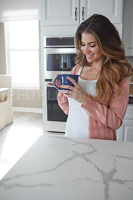 Buy stock photo Shot of a beautiful young woman having coffee in the kitchen at home