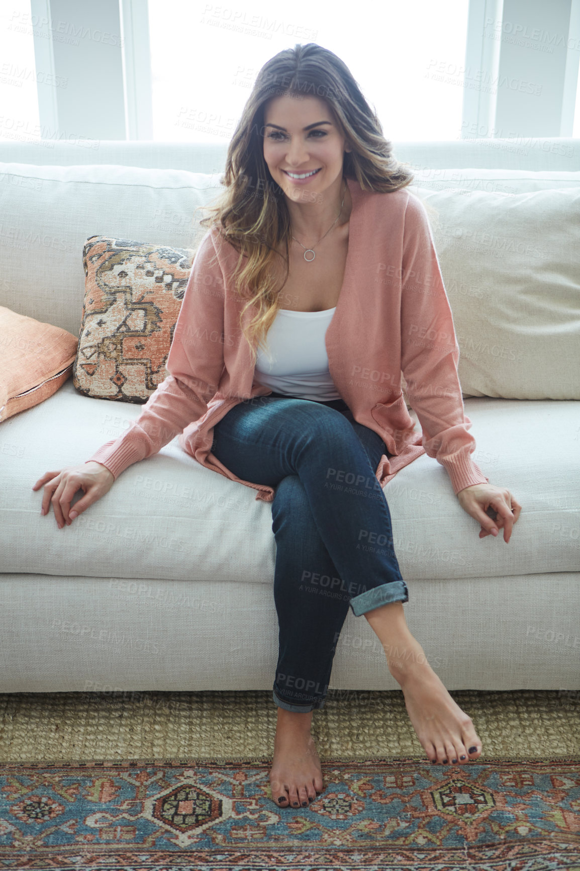 Buy stock photo Shot of a beautiful young woman relaxing on a sofa at home