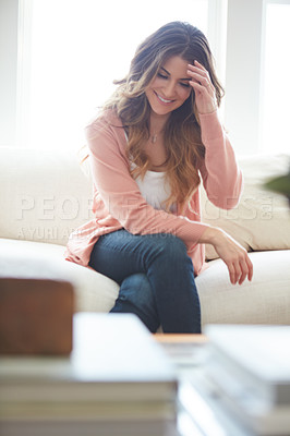 Buy stock photo Shot of a beautiful young woman relaxing on a sofa at home