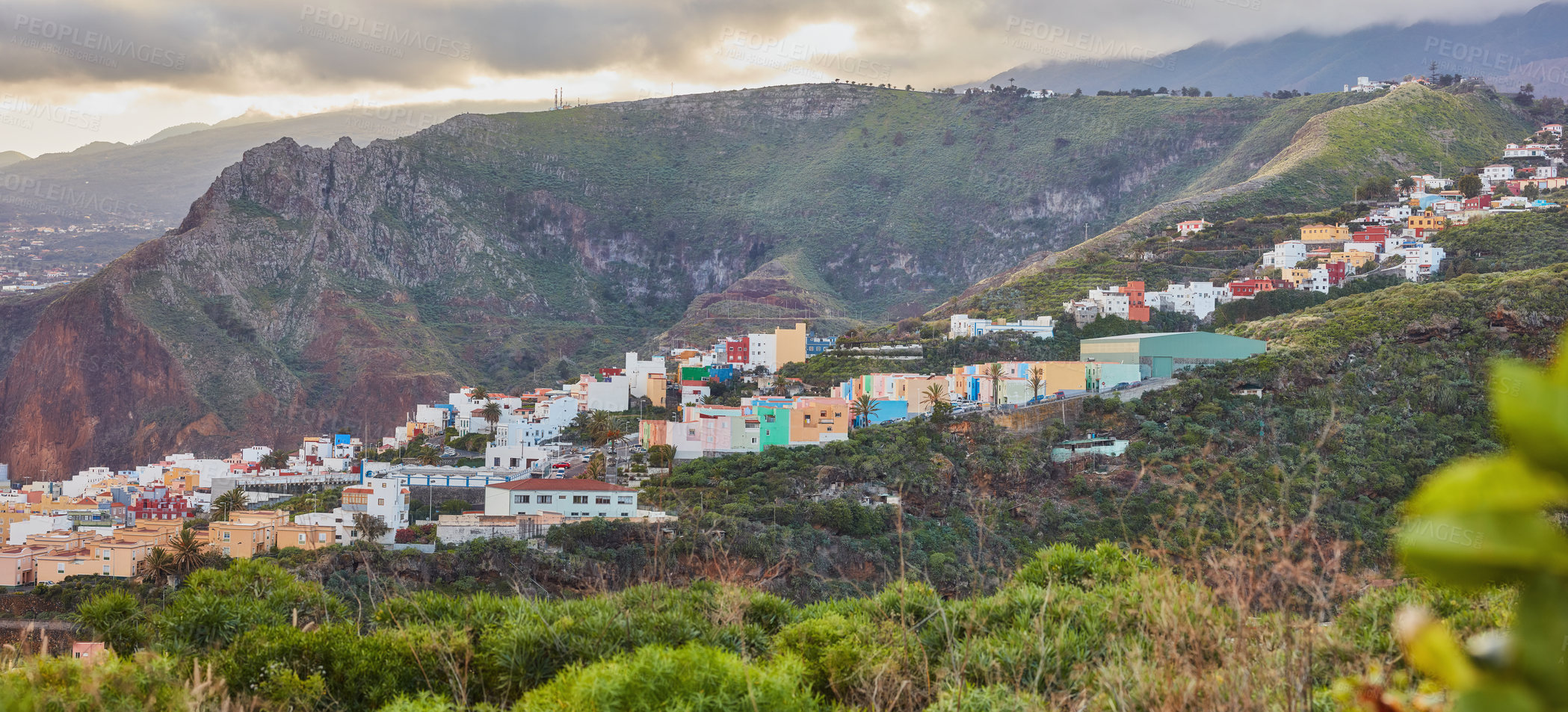 Buy stock photo Colorful buildings in Santa Cruz, La Palma, Canary Islands with copy space. Beautiful cityscape with bright colors and mountains. A vibrant holiday, vacation and getaway destination on the hillside 