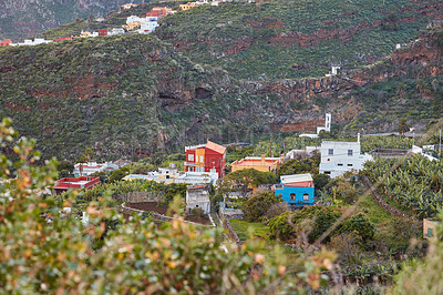 Buy stock photo A small vibrant town or village surrounded by lush green plants or nature on an overcast afternoon in the mountains. View of the beautiful city of Los Llanos, La Palma, and the Canary Islands