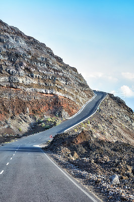 Buy stock photo Empty road in the mountains with a clear blue sky. Landscape of a countryside roadway for traveling on a mountain pass along a beautiful scenic nature drive in La Palma, Canary islands in Spain 