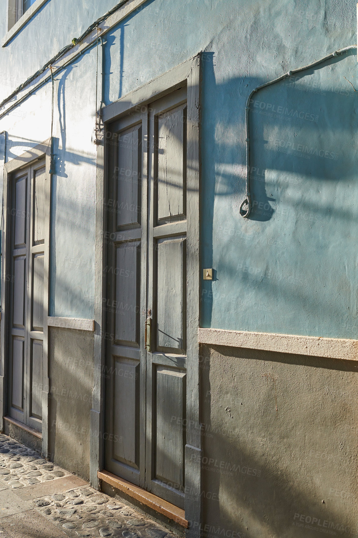 Buy stock photo Historic Spanish architecture outdoors of a building in a overseas. Backdoor of a home or residential building. Two old blue doors to a traditional house outside in Santa Cruz de La Palma, Spain.