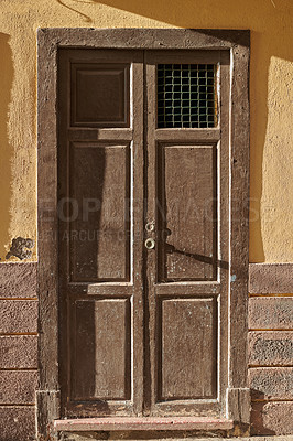 Buy stock photo Weathered and damaged architectural structure with rustic, aged pattern and frame on an entrance or doorway in Spain. An old wooden vintage door of an ancient building in Santa Cruz de La Palma.