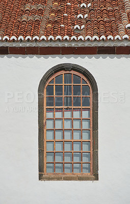 Buy stock photo Architecture of a grey wall with an arched window outside. Exterior texture details of an old rustic residential building or church with vintage wooden windows discovered in Santa Cruz de La Palma