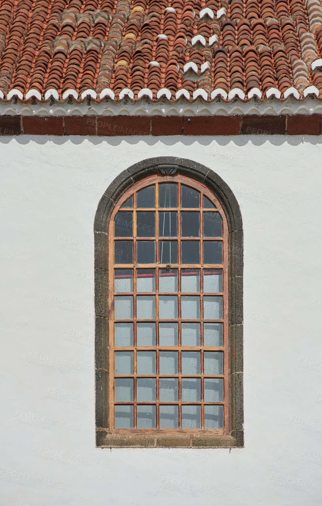 Buy stock photo Architecture of a grey wall with an arched window outside. Exterior texture details of an old rustic residential building or church with vintage wooden windows discovered in Santa Cruz de La Palma