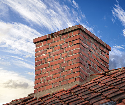 Buy stock photo Closeup of red brick chimney chute against blue sky with clouds for combustion gas or home insulation on tiled roof. Architecture design on house building for smoke extraction from fireplace furnace