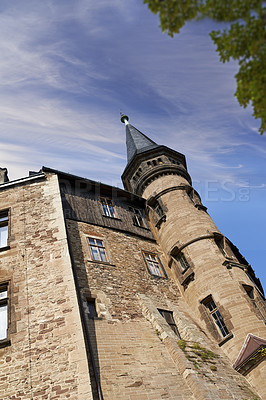 Buy stock photo Exterior of a gothic victorian building in the style of England Gothic Revival on a cloudy blue sky with copy space. Low architecture detail of an historical church tower structure or University