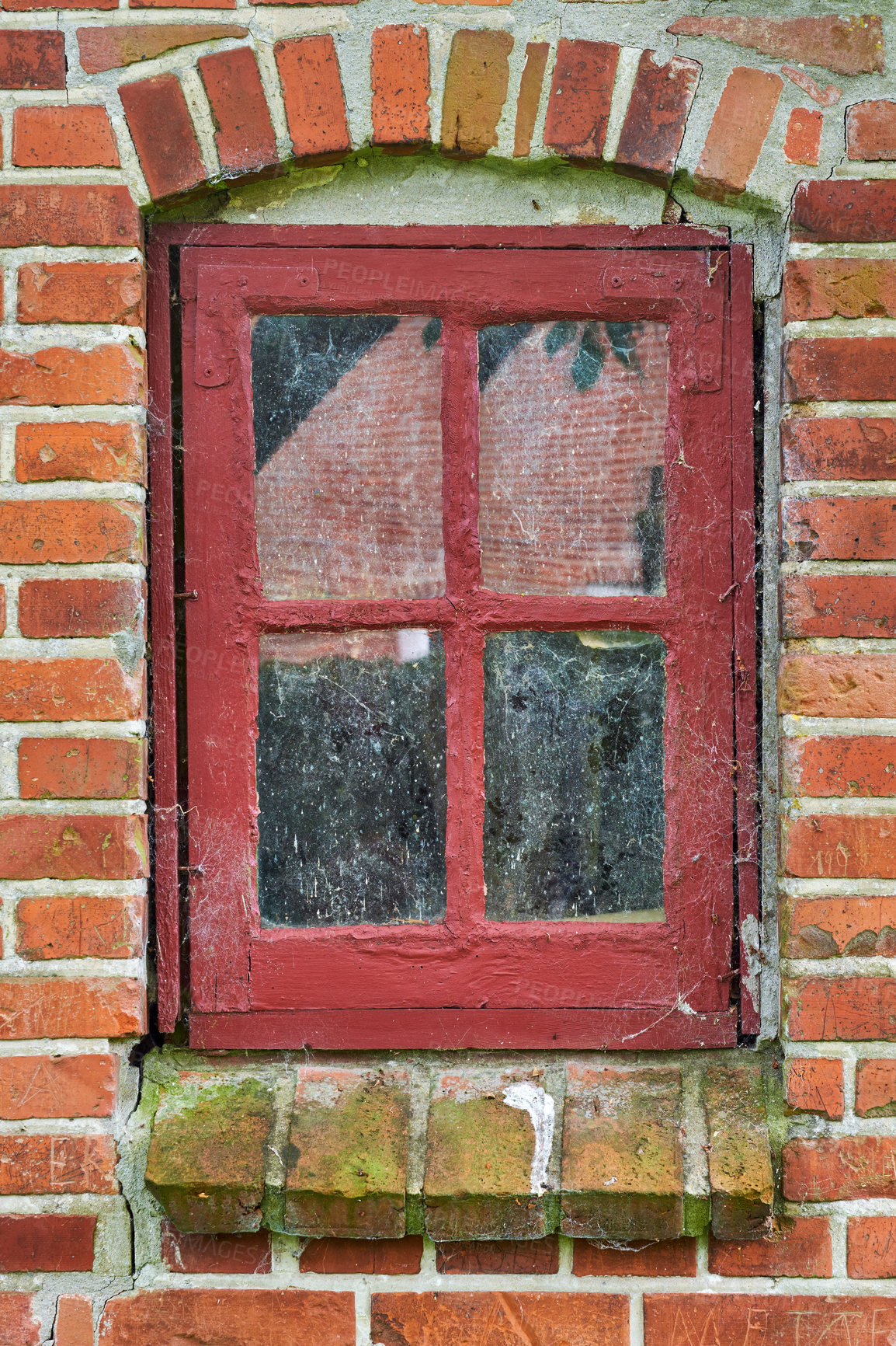 Buy stock photo Closeup of abandoned red window covered in spiderwebs, algae and moss from neglect, poverty and economic crisis. Empty, old residential building or home in a village with damp mold on the windowsill