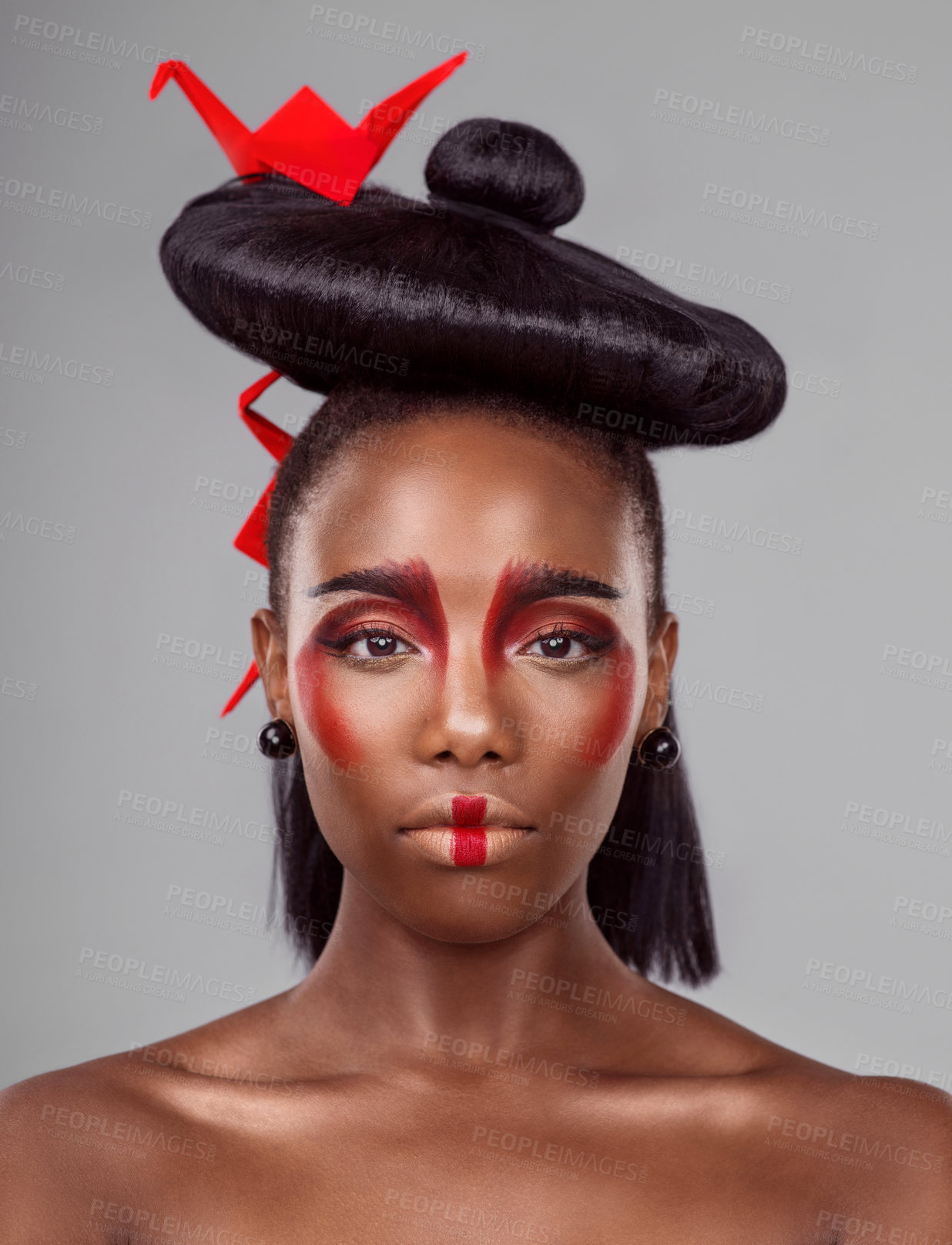 Buy stock photo Portrait, cosmetics and black woman with origami for beauty in studio isolated on gray background. Face, creative makeup and confident serious model with red paper bird in hair, skincare and art