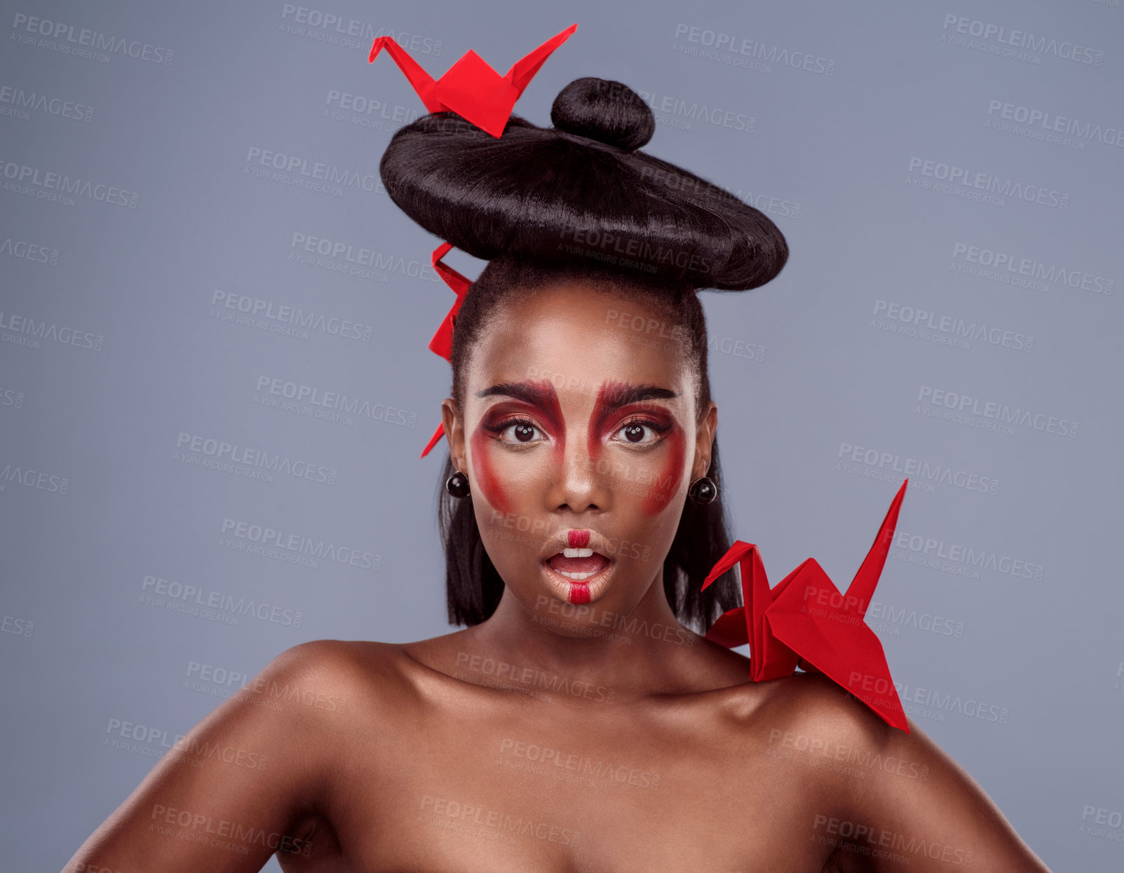 Buy stock photo Portrait, makeup and surprise of black woman with origami for beauty in studio isolated on gray background. Shocked face, creative cosmetics and model with paper crane in hair, skincare and art color