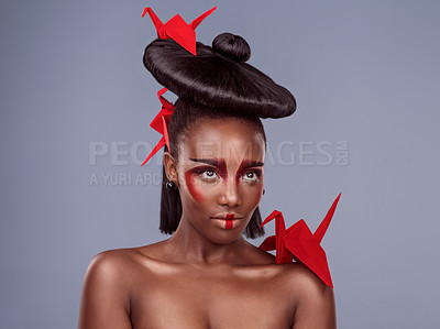 Buy stock photo Beauty, makeup and origami with black woman on gray background for creative, cosmetics and asian aesthetic. Traditional, paper design and female model for heritage, art and confidence in studio