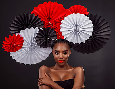 Buy stock photo Origami fans, portrait and a black woman for culture isolated on a black background in a studio. Paper, creative and an African model with art design for tradition, color and Japanese celebration