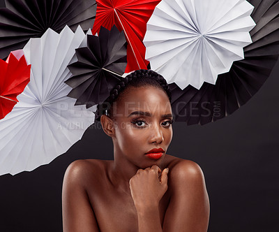 Buy stock photo Woman, portrait and beauty with origami fans in studio isolated on a dark background. Face, makeup cosmetics and skincare of black female model with traditional Japanese paper art for culture hat