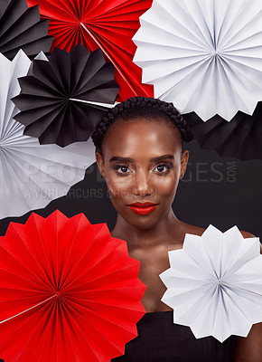 Buy stock photo Black woman, portrait and beauty with origami fans in studio isolated on dark background. Face, makeup and female model confident with traditional craft paper art for creative expression and fashion