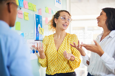 Buy stock photo Shot of a group of young businesspeople having a brainstorming session in a modern office