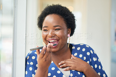 Buy stock photo Shot of a happy young businesswoman using a smartphone in a modern office