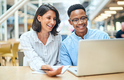 Buy stock photo Shot of a young businessman and businesswoman using a laptop in a modern office