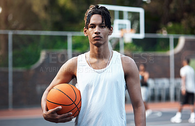 Buy stock photo Portrait of a sporty young man standing on a basketball court