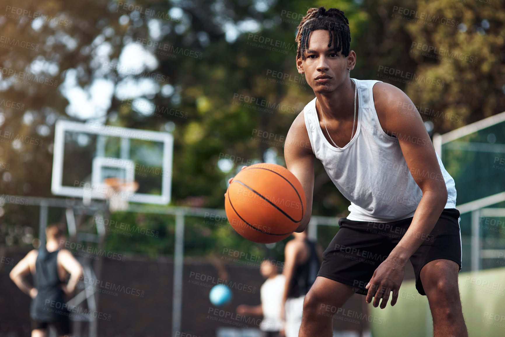 Buy stock photo Portrait of a sporty young man standing on a basketball court