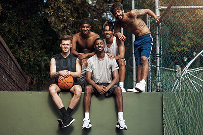 Buy stock photo Portrait of a group of sporty young men hanging out on a basketball court