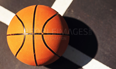 Buy stock photo Still life shot of a basketball on the ground in a sports court