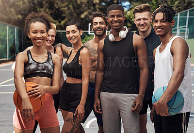 Buy stock photo Portrait of a group of sporty young people standing together on a sports court