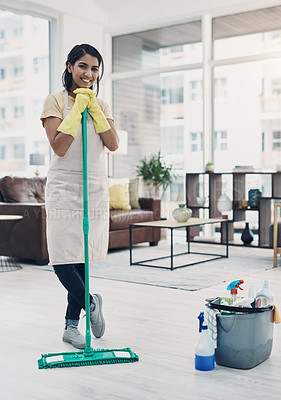 Buy stock photo Shot of a young woman cleaning her home