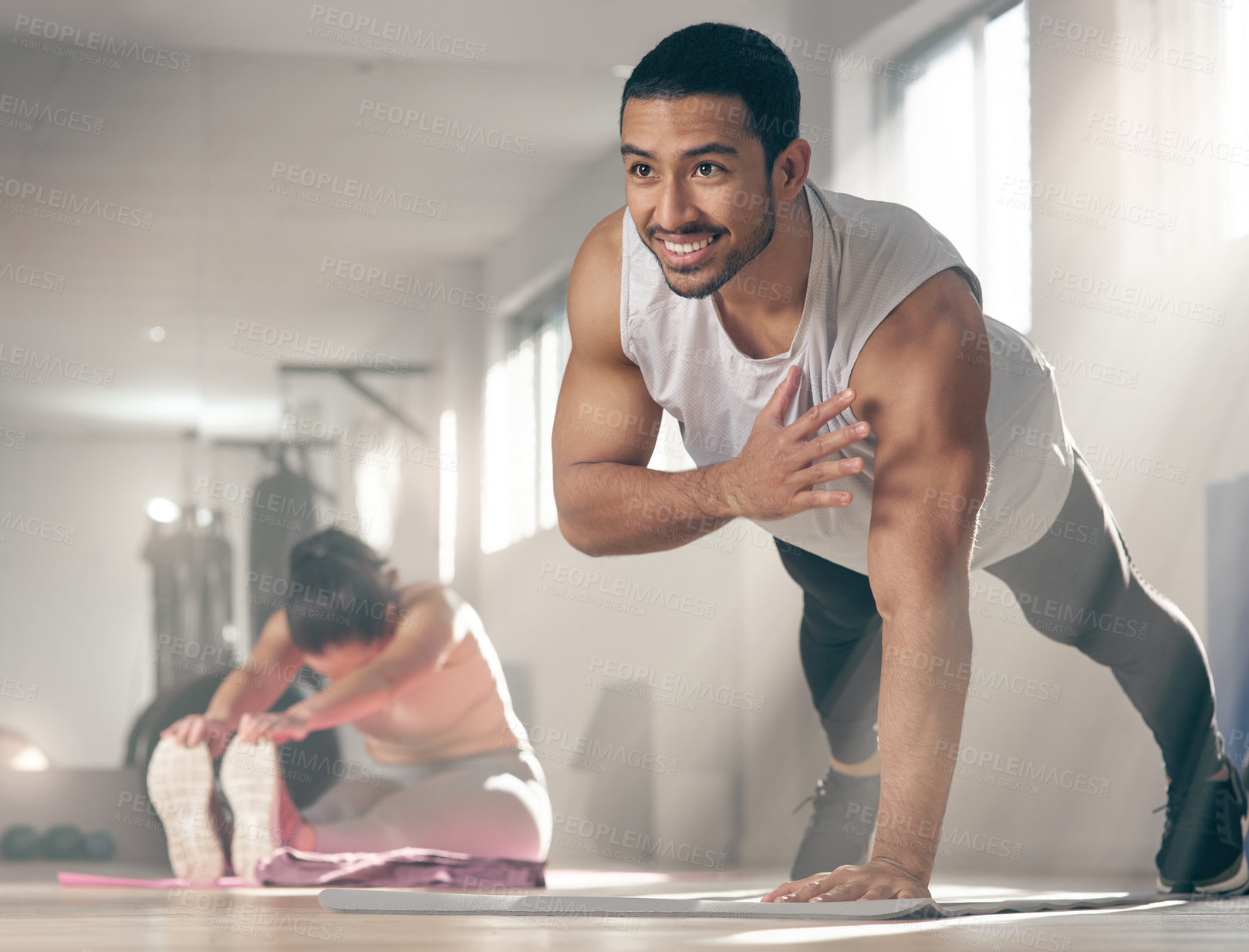 Buy stock photo Exercise, push up and smile with man in gym for physical conditioning, training or workout routine. Balance, fitness and strength with happy athlete in health club for challenge or performance