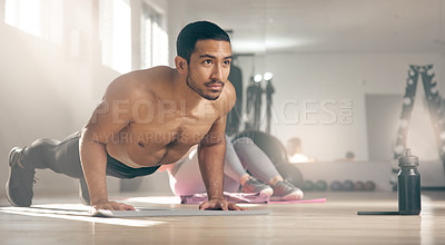 Buy stock photo Shot of a young male athlete working out at the gym