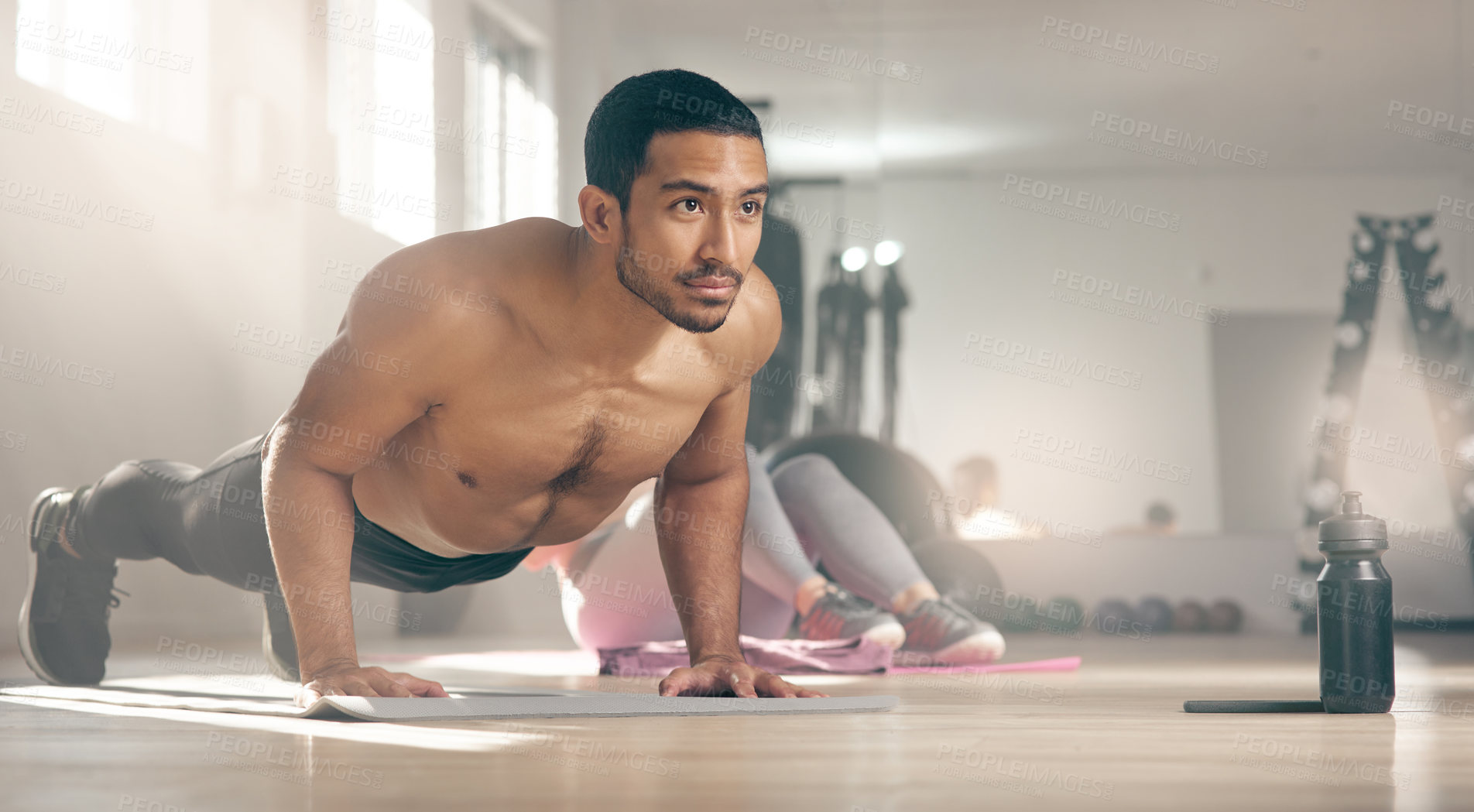 Buy stock photo Shot of a young male athlete working out at the gym