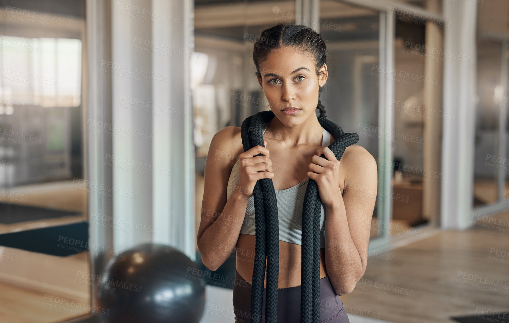 Buy stock photo Shot of a young female athlete posing with a rope around her neck