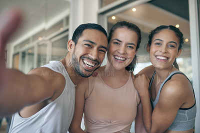 Buy stock photo Shot of three young athletes taking a selfie while standing together in the gym