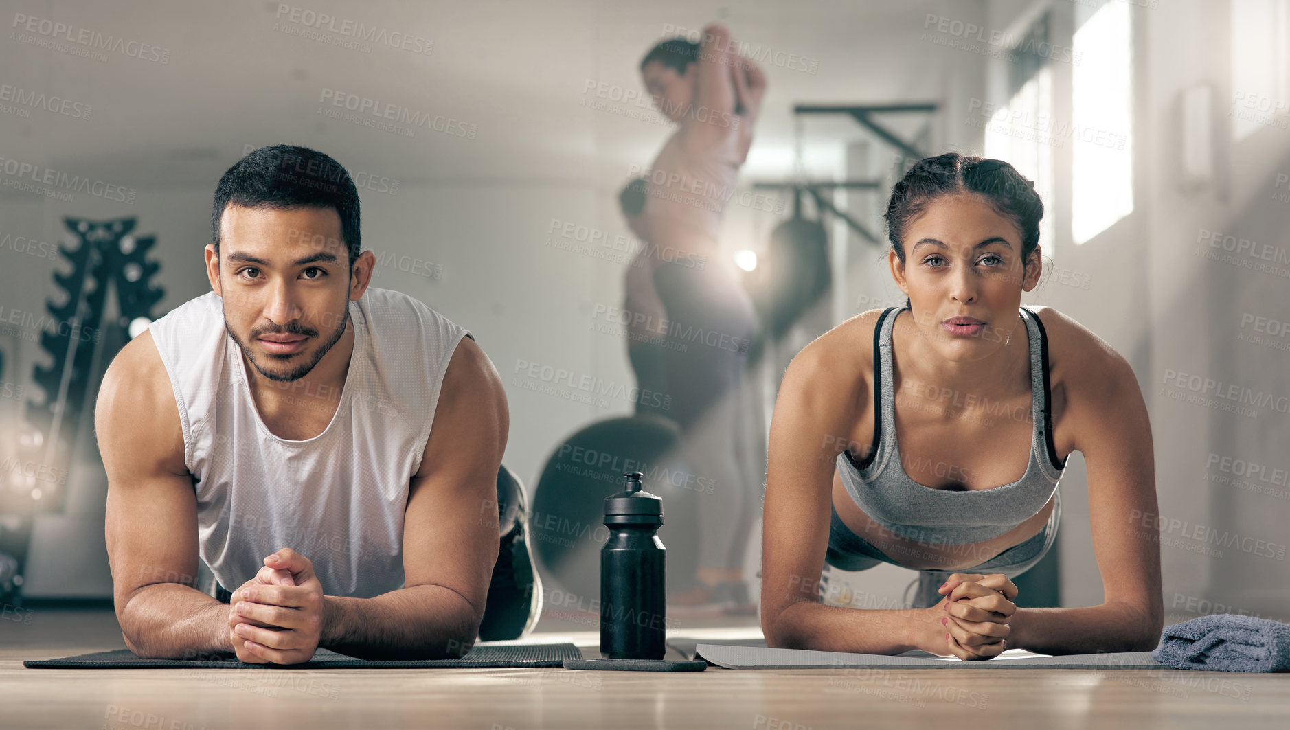 Buy stock photo Shot of two young athletes working out together at the gym