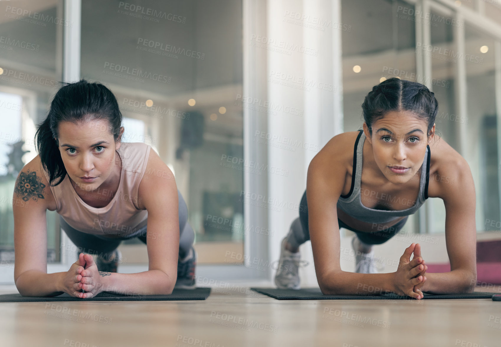 Buy stock photo Shot of two young athletes working out together at the gym
