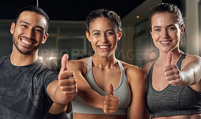 Buy stock photo Cropped portrait of three young athletes giving thumbs up while standing in the gym