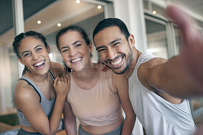 Buy stock photo Cropped portrait of three young athletes taking selfies while standing in the gym