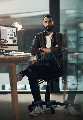 Buy stock photo Portrait of a confident young businessman working late at night in a modern office