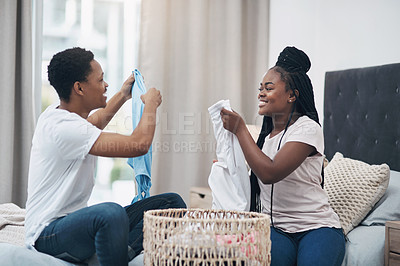 Buy stock photo Shot of a young couple doing laundry together at home