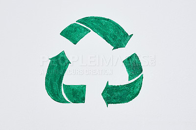 Buy stock photo Shot of a green recycle symbol painted on a wall