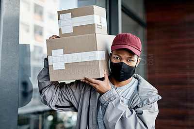 Buy stock photo Shot of a masked young man delivering a package to a place of residence