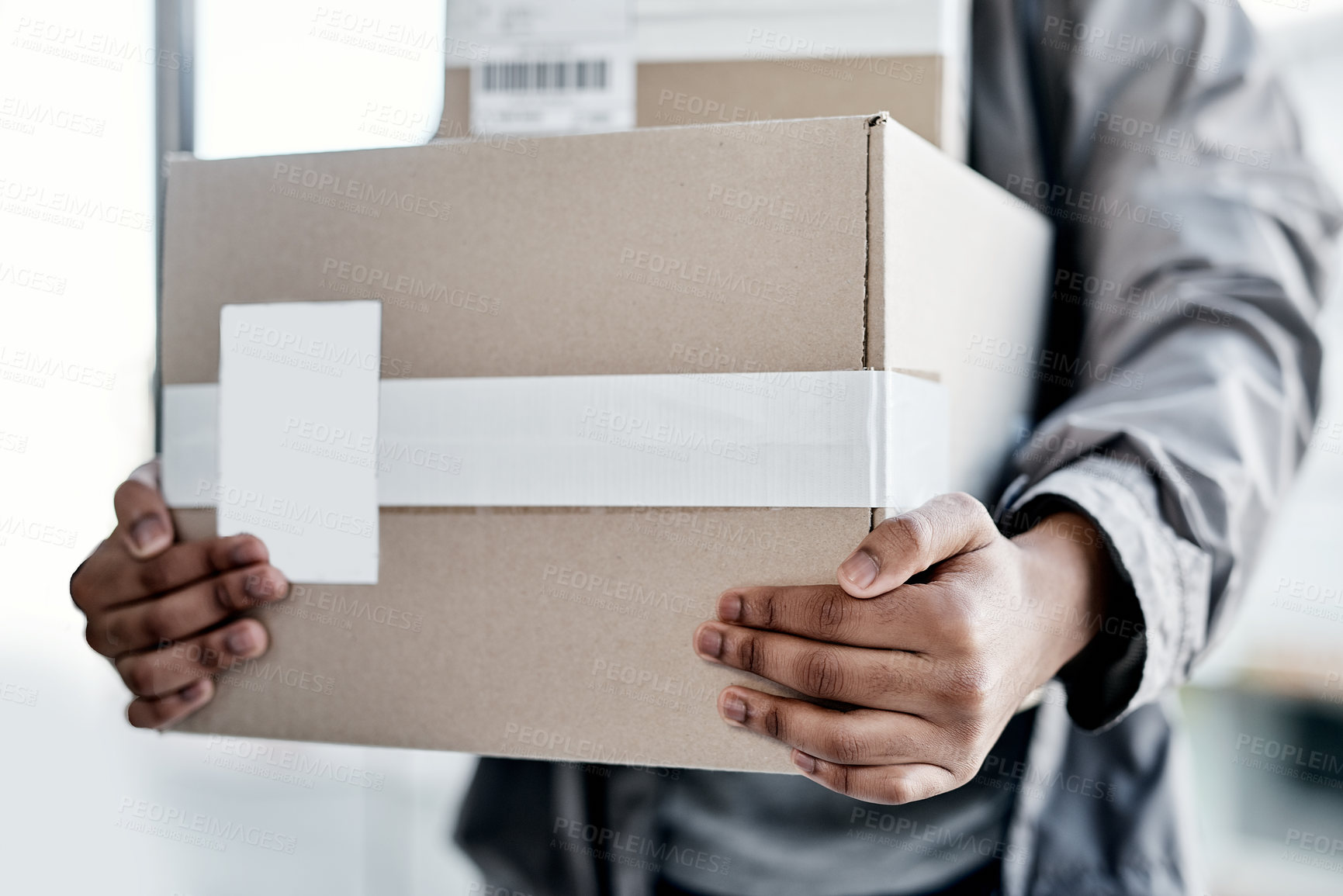 Buy stock photo Cropped shot of a man delivering a package to a place of residence