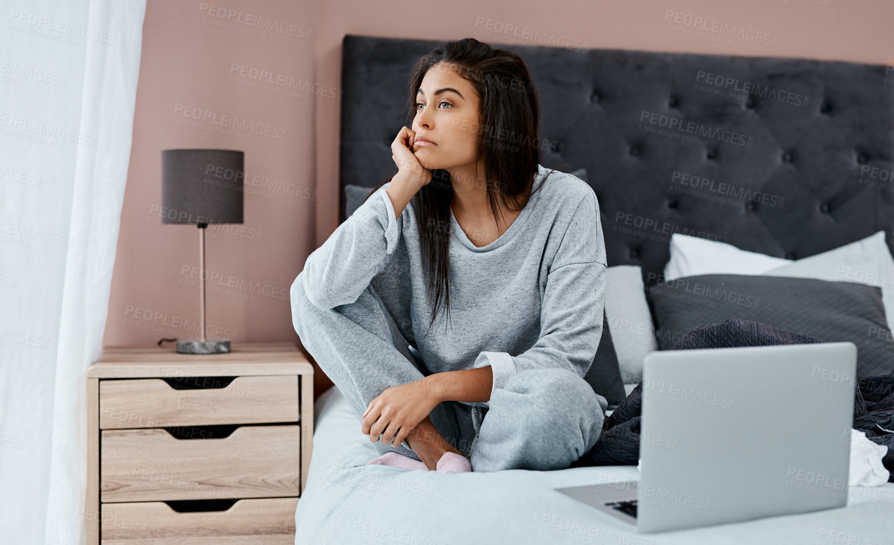 Buy stock photo Shot of a young woman looking thoughtful while recovering from an illness in bed at home