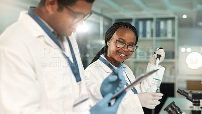Buy stock photo Portrait of a young scientist working alongside a colleague in a lab
