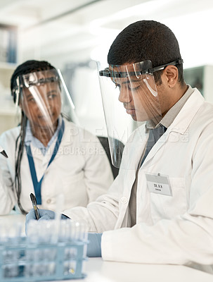 Buy stock photo Shot of two scientists working together in a lab