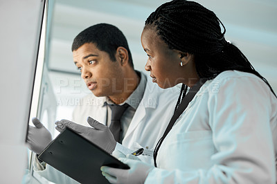 Buy stock photo Shot of two scientists working together in a lab