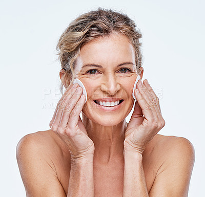 Buy stock photo Shot of a mature woman holding cotton pads against her face