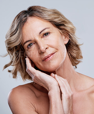 Buy stock photo Shot of a beautiful mature woman posing against a white background