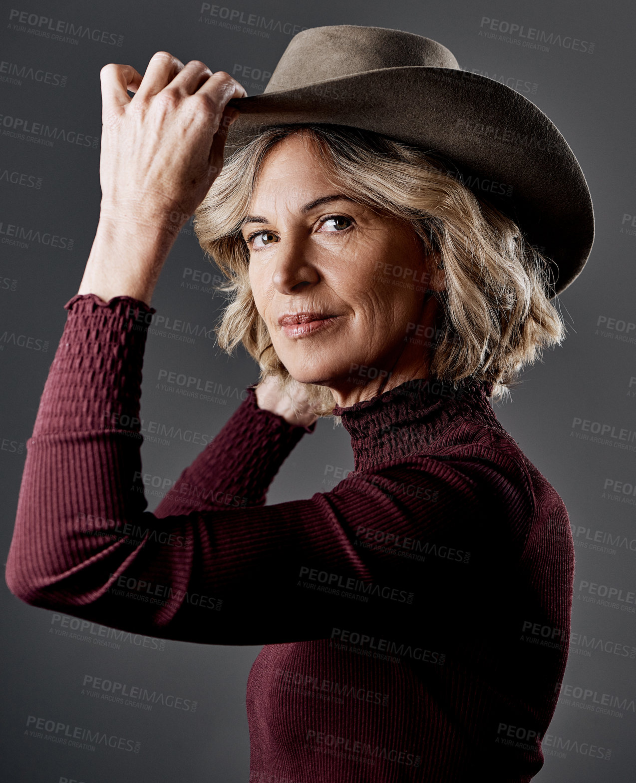 Buy stock photo Cropped shot of a mature woman looking stylish against a grey background